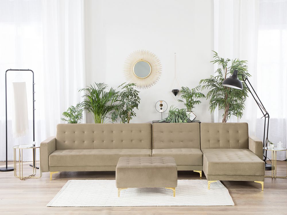 Sofá cama esquinero de terciopelo beige claro con reposapiés izquierdo