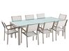 Nyolcszemélyes étkezőasztal repedezett üveglappal és fehér textilén székekkel GROSSETO_677338